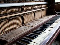 Old broken disused piano with damaged keys