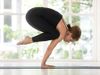 Woman practicing crane pose or bakasana. Yoga, asana, stretches, stretching, exercise