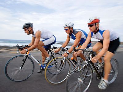 Three cyclists riding bikes. Bicycle, biker, commuter, bike to work. Hompepage blog 2009, arts and entertainment, history and society, sports and games athletics swimming pool