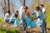 Community service - volunteers picking up garbage in a park during a spring cleanup. Environmentalism