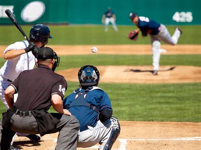 Pitcher releases pitch, heading towards batter (baseball, sports, catcher, umpire).