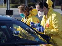 Health care workers tend to patients at the drive-in center at ProHealth Care on March 18, 2020 in Jericho, New York. The facility offers COVID-19 testing as more than 200,000 people in at least 144 countries have been infected, with deaths in the....