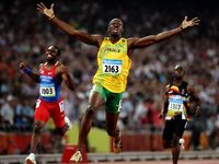 Usain Bolt of Jamaica reacts after breaking the world record with a time of 19.30 to win the gold medal as Churandy Martina (left) of Netherlands Antilles and Brian Dzingai of Zimbabwe come in after him in the Men's 200m Final at the National Stadium during Day 12 of the Beijing 2008 Olympic Games on August 20, 2008 in Beijing, China. (Summer Olympics, track and field, athletics)