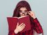 Young woman with glasses reading a book, student