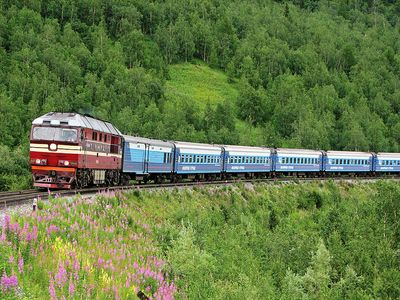 A train passes through the central Ural Mountains in Russia.