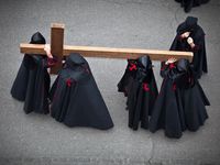 Holy week. Easter. Valladolid. Procession of Nazarenos carry a cross during the Semana Santa (Holy week before Easter) in Valladolid, Spain. Good Friday