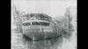 See recovery workers righting the capsized Eastland in the Chicago River, 1915