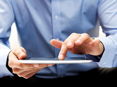 White male businessman works a touch screen on a digital tablet. Communication, Computer Monitor, Corporate Business, Digital Display, Liquid-Crystal Display, Touchpad, Wireless Technology, iPad