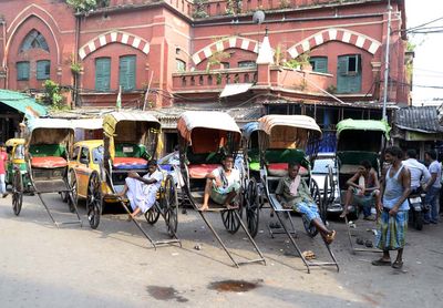 Hand pulled rickshaw drivers wait for passenger and try to stay cool in extreme heat on a summer afternoon May 20, 2015 in Calcutta, India. India heat wave, India heatwave, ricksha