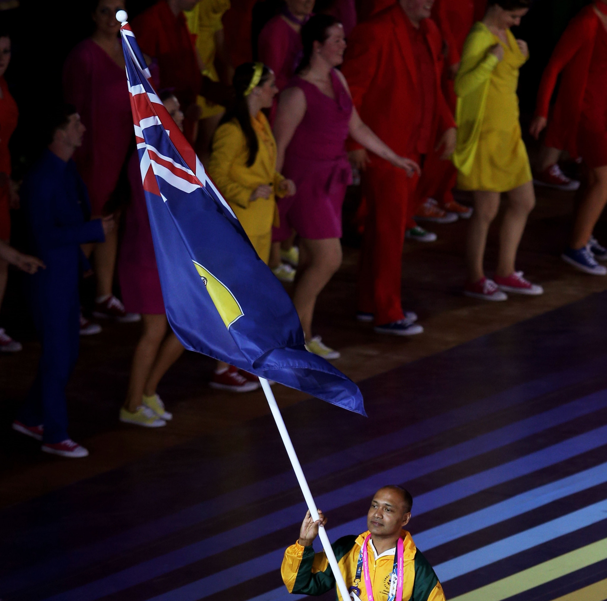Shooter Simon Henry carries the St Helena flag at the Glasgow 2014 Commonwealth Games ©Getty Images