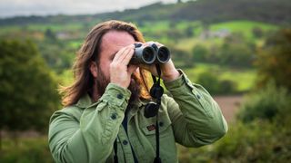 Expert holds one of the best binoculars while observing
