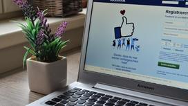 Работающий ноутбук с главной страницей социальной сети Facebook на экране