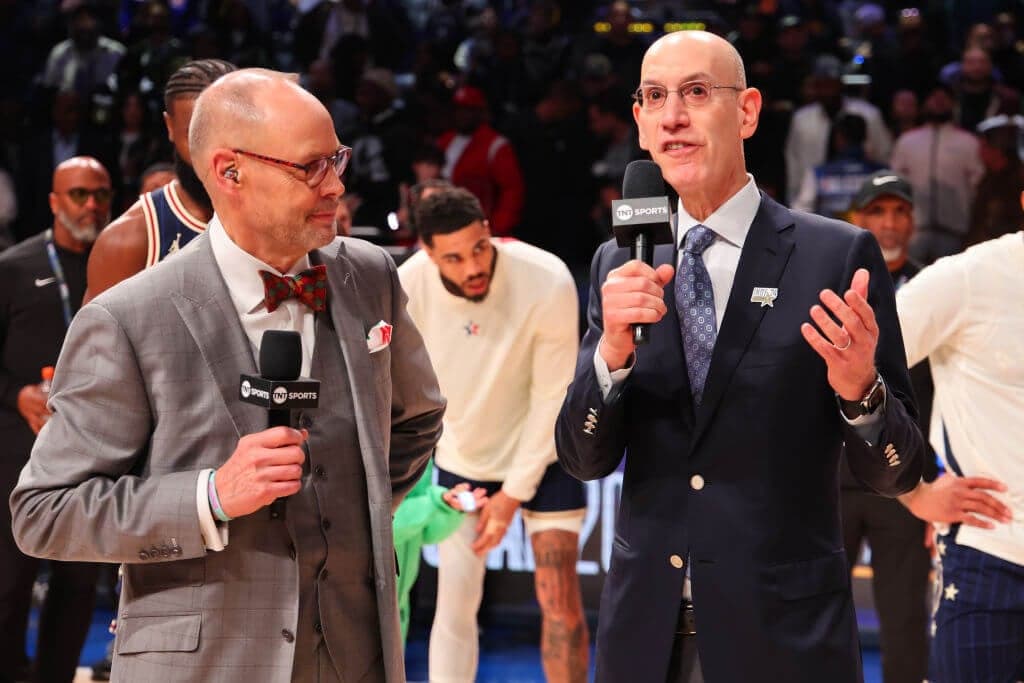 INDIANAPOLIS, INDIANA - FEBRUARY 18: Ernie Johnson Jr. and  NBA Commissioner Adam Silver speak on the court during the 2024 NBA All-Star Game at Gainbridge Fieldhouse on February 18, 2024 in Indianapolis, Indiana. NOTE TO USER: User expressly acknowledges and agrees that, by downloading and or using this photograph, User is consenting to the terms and conditions of the Getty Images License Agreement. (Photo by Stacy Revere/Getty Images)