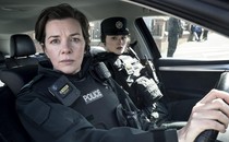 Two female cops from Blue Lights sit in a car