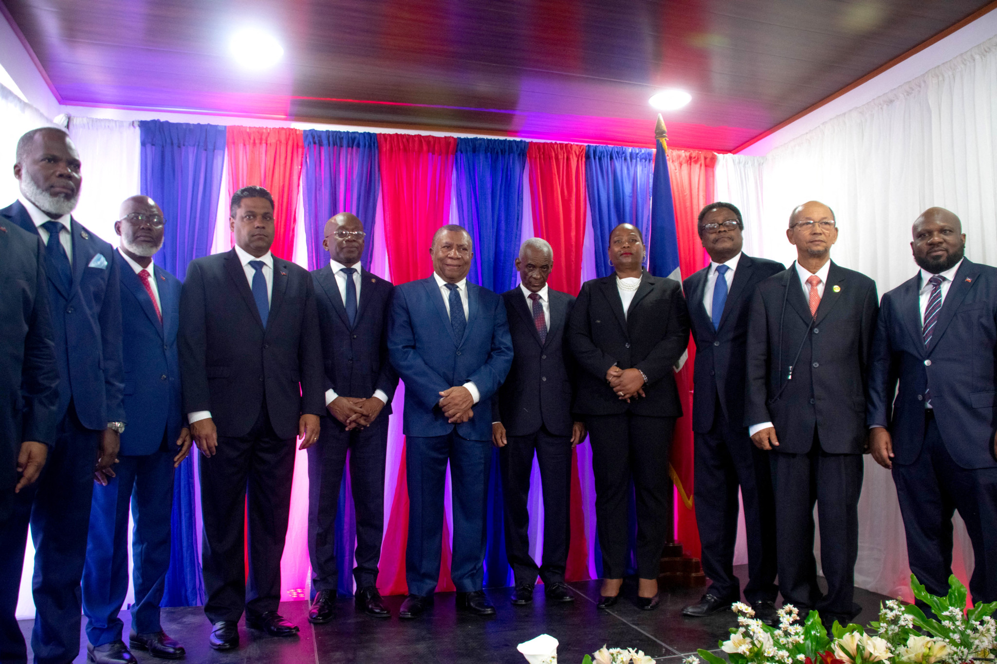 The members of the new Haitian transitional council pose after being sworn in at the National Palace in Port-au-Price, Haiti, on April 25, 2024. A long-awaited transitional ruling council was sworn in in crisis-torn Haiti Thursday, an official told AFP, the first step to forming a new government after months of gang violence in the Caribbean nation. (Photo by Clarens SIFFROY / AFP)