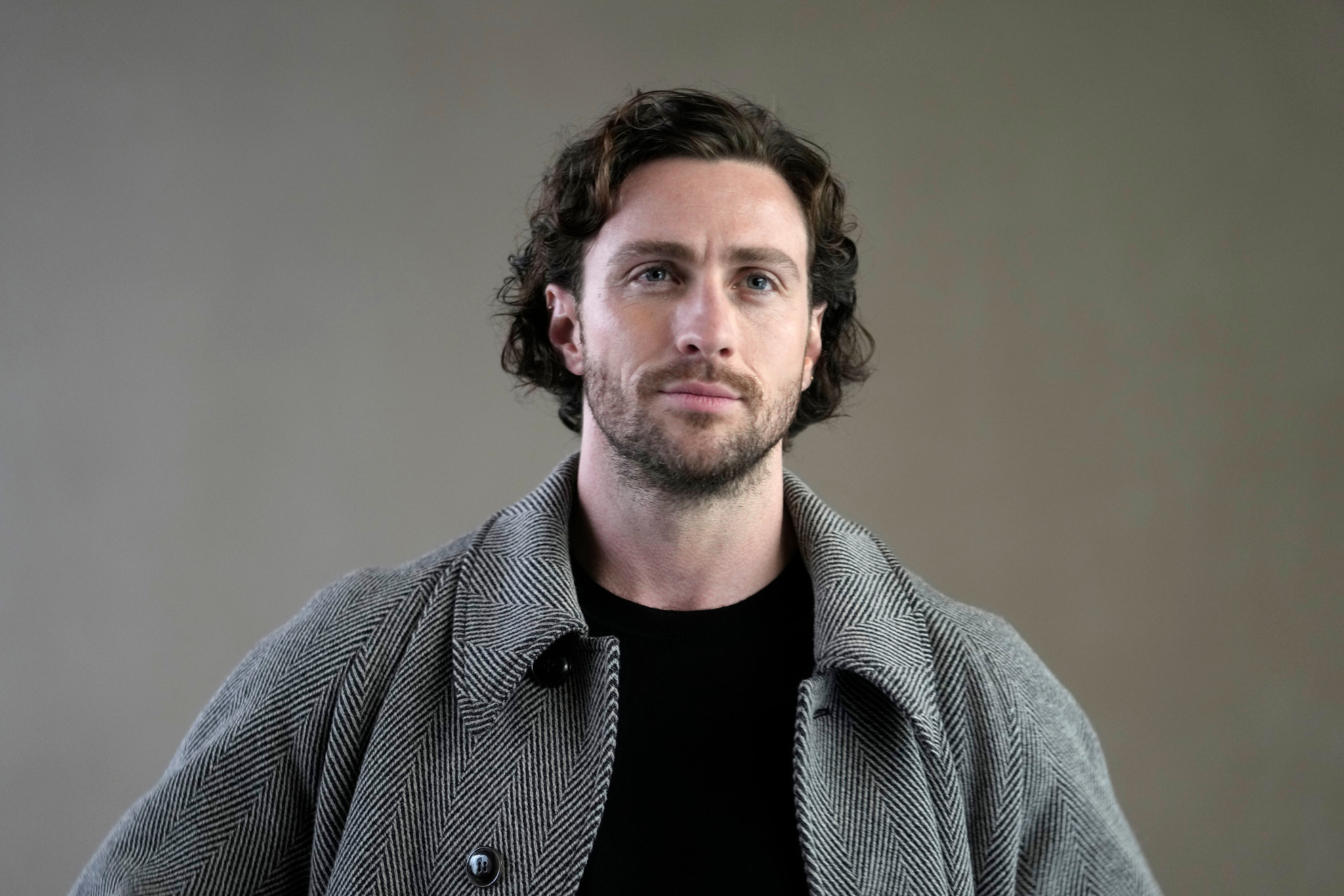 Actor Aaron Taylor-Johnson attends the Giorgio Armani women's Fall-Winter 2024-25 collection presented in Milan, Italy, Sunday, Feb. 25, 2024. (AP Photo/Luca Bruno)