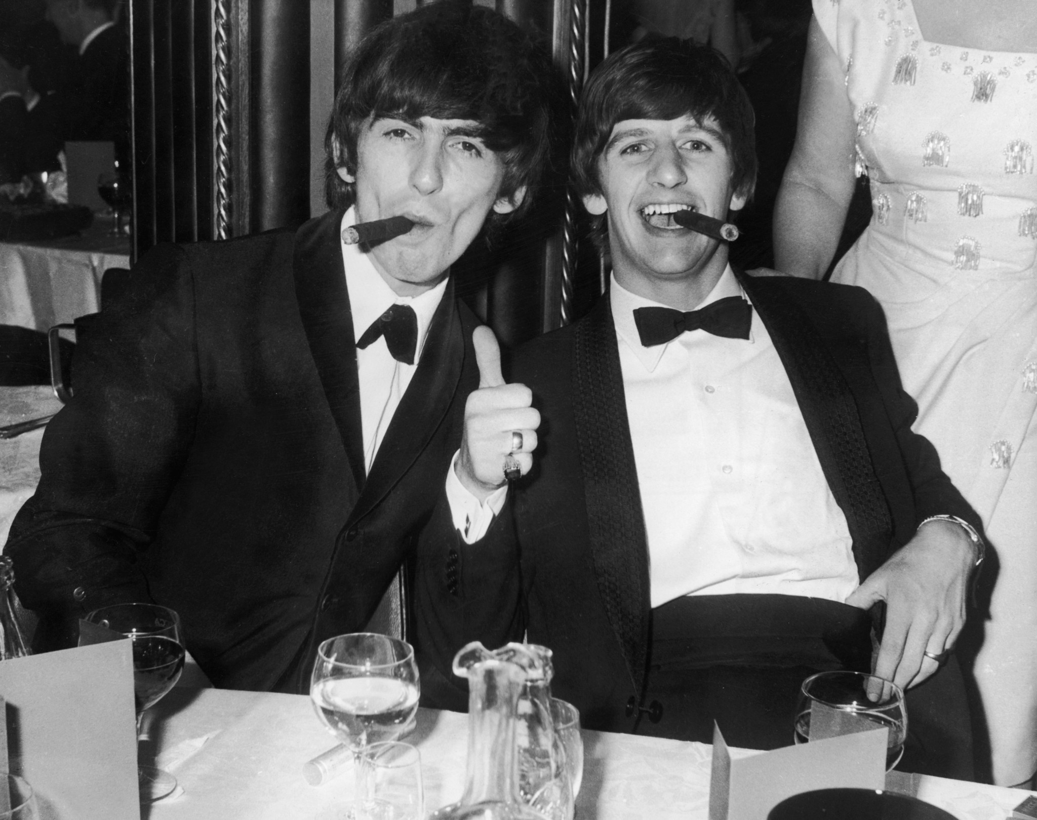 392279 10: (FILE PHOTO) Beatles George Harrison (L) and Ringo Starr smoke cigars in tuxedos after the presentation of the Carl Allen Awards March 23, 1964 in London. It was reported November 8, 2001 that Harrison is undergoing cancer treatment in a Staten Island, NY hospital. The 58-year-old ex-Beatle was diagnosed with lung cancer and a brain tumor earlier this year. (Photo by Getty Images)
