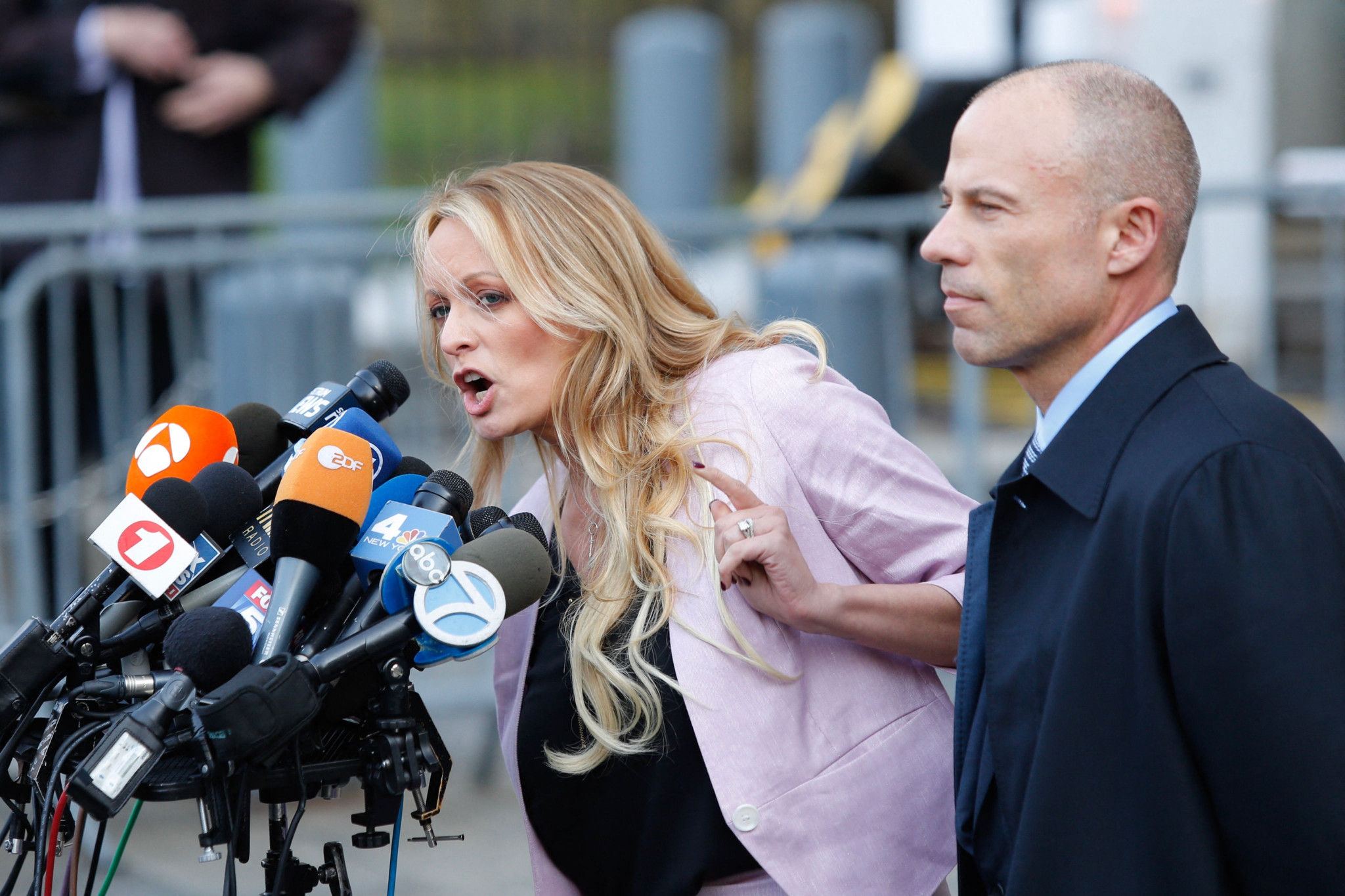 (FILES) Adult-film actress Stephanie Clifford, also known as Stormy Daniels speaks US Federal Court with her lawyer Michael Avenatti (R) on April 16, 2018, in Lower Manhattan, New York. Donald Trump goes on trial on April 15, 2024 for allegedly covering up hush money payments to hide affairs ahead of the 2016 presidential election which propelled him into the White House. (Photo by EDUARDO MUNOZ ALVAREZ / AFP)