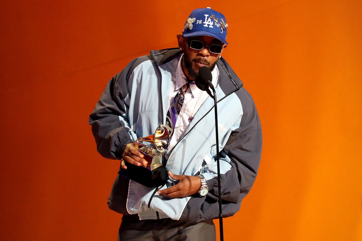 Kendrick Lamar holding a Grammy Award.