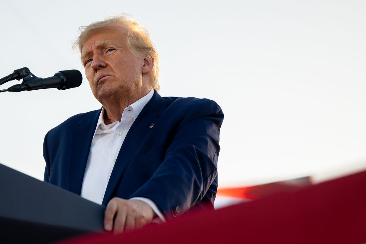 Donald Trump stands at a lectern. 