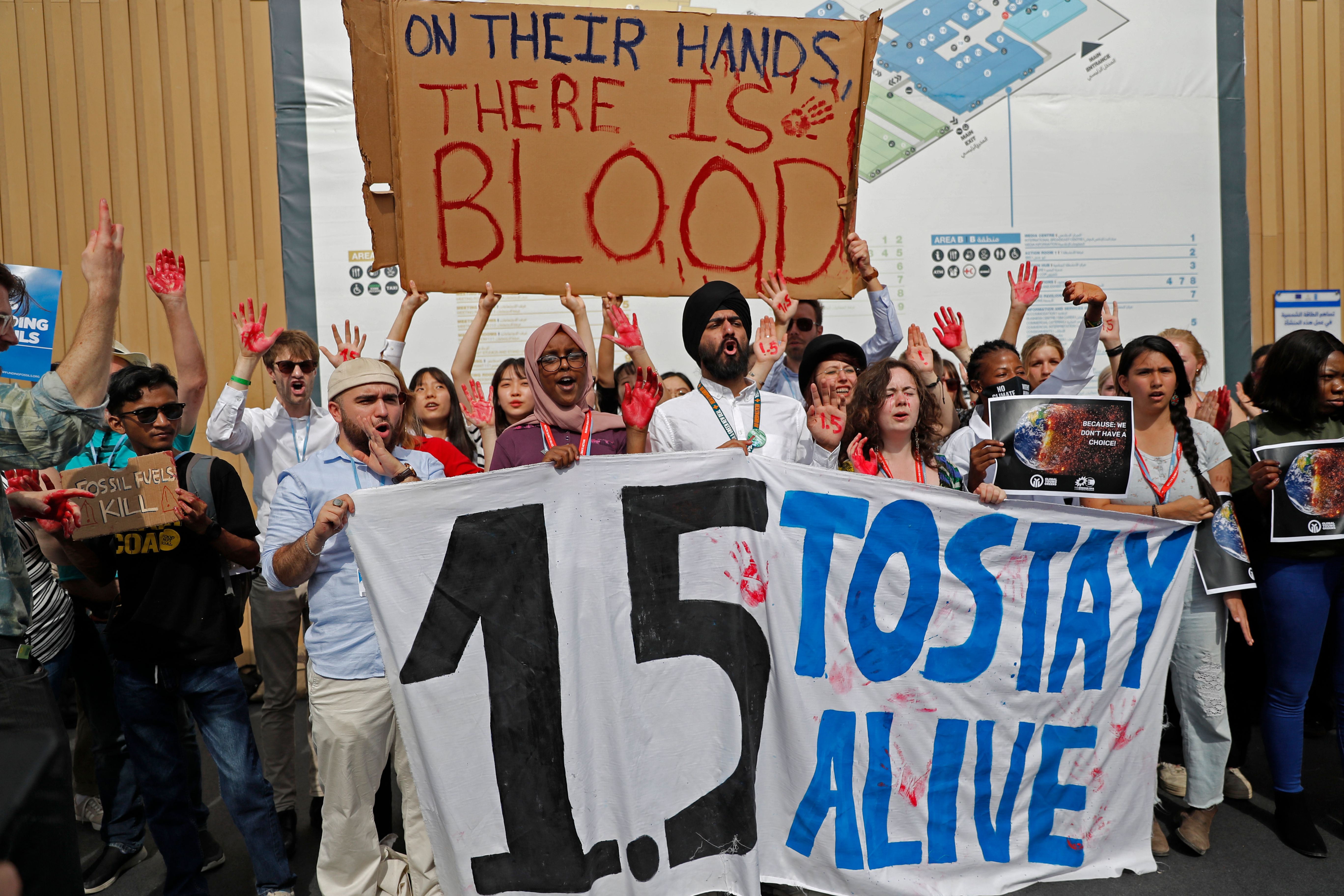 Activists chant slogans as they hold up a banner reading “1.5 to stay alive,” referring to demands to limit global temperature rise to 1.5 degrees Celsius compared to pre-industrial levels, during a demonstration at the COP27 climate conference in Sharm el-Sheikh, Egypt in 2022.