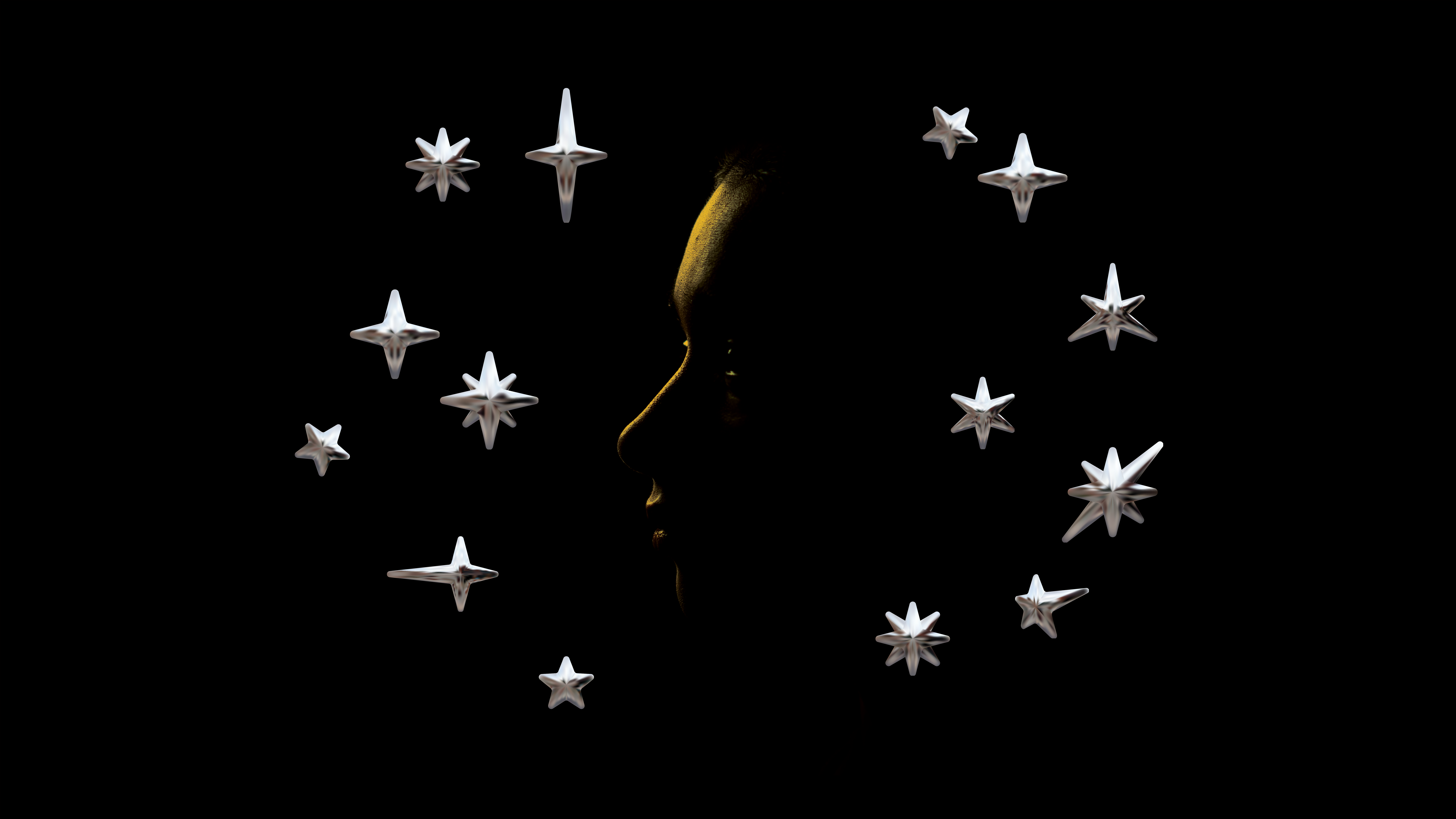 The silhouette of a young woman on a black background has golden backlighting. 3D-rendered metallic star shapes surround her face.