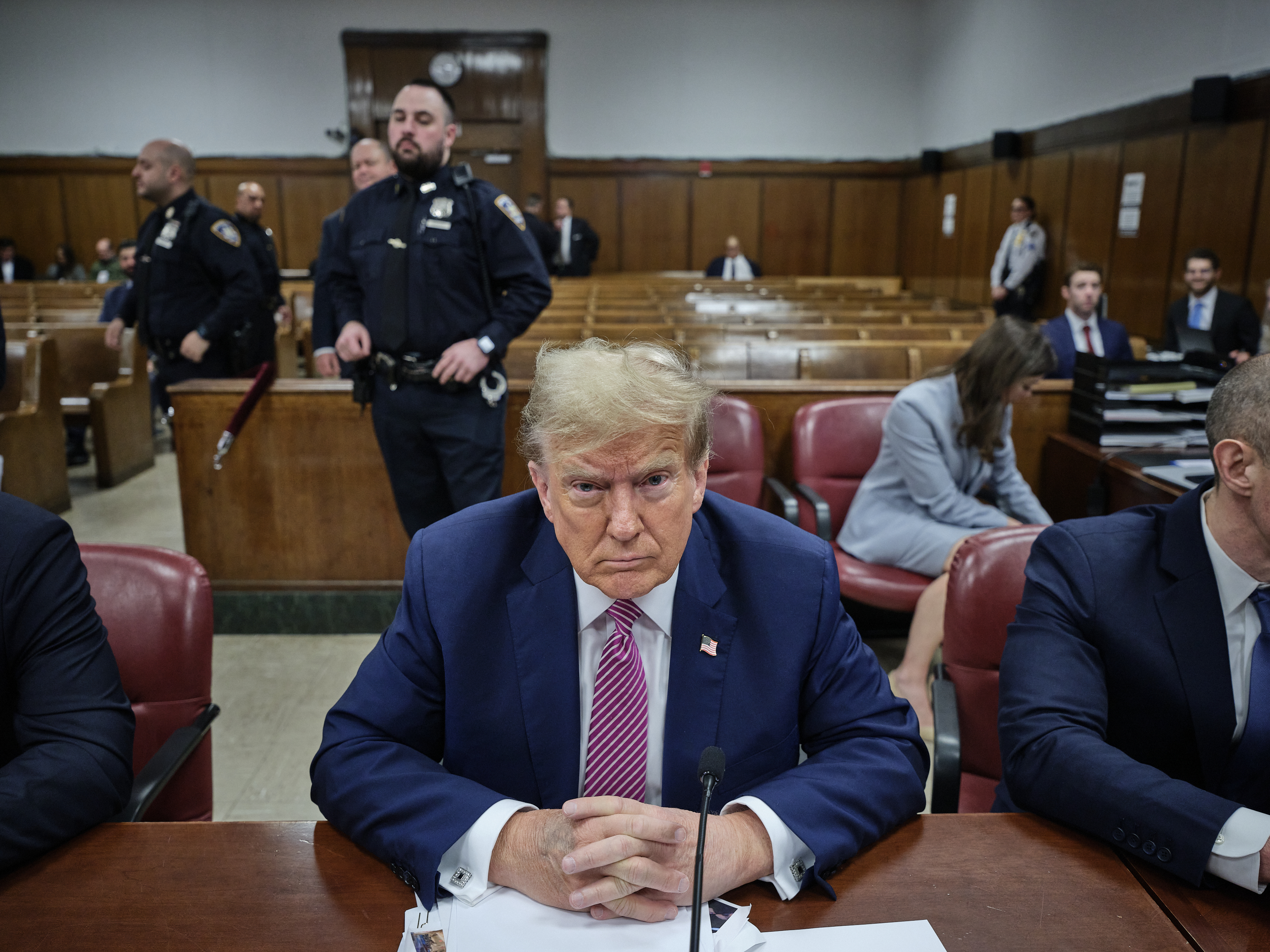 Trump sitting at a table in a courtroom.