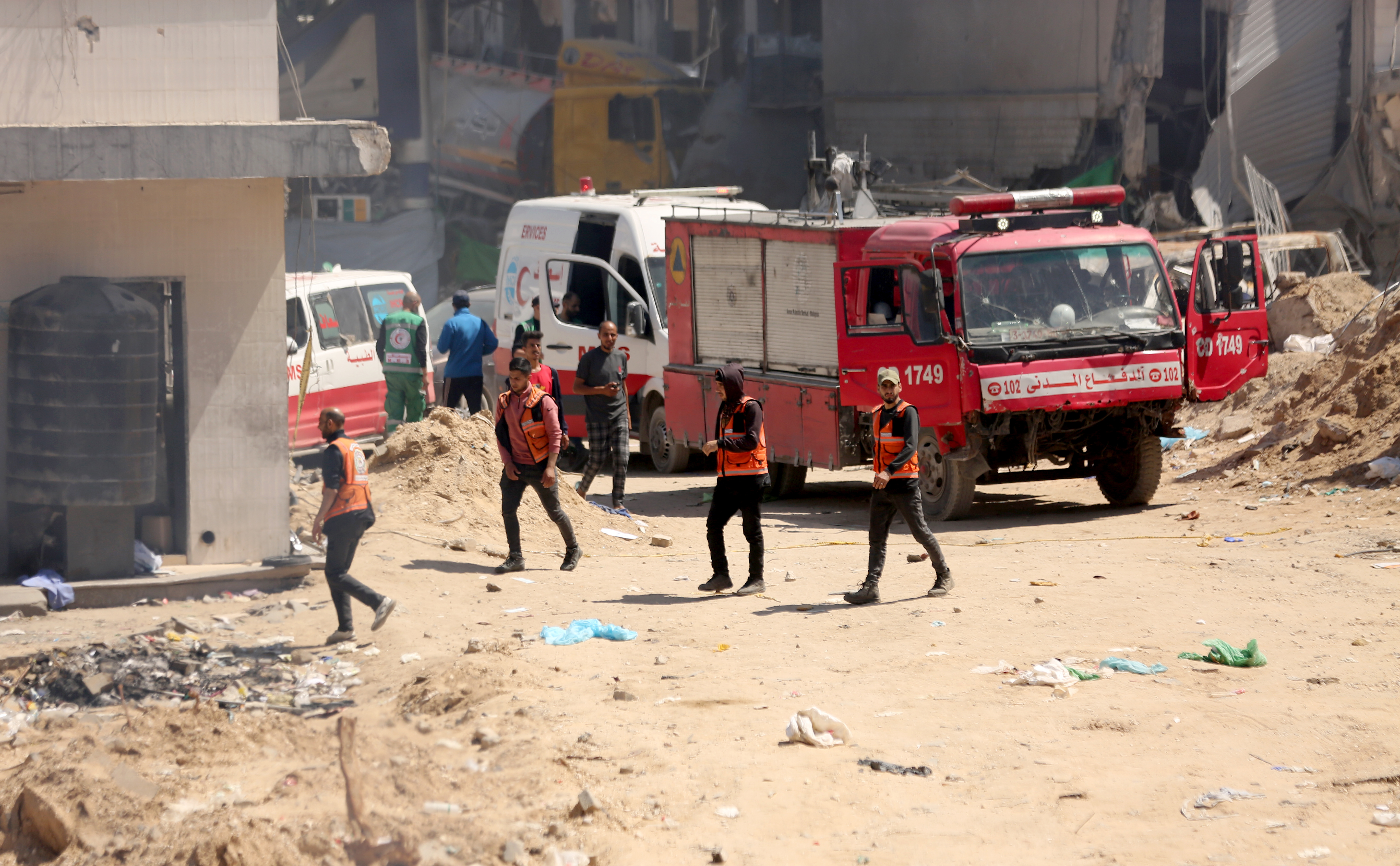 Emergency vehicles and workers outside a bombed hospital.