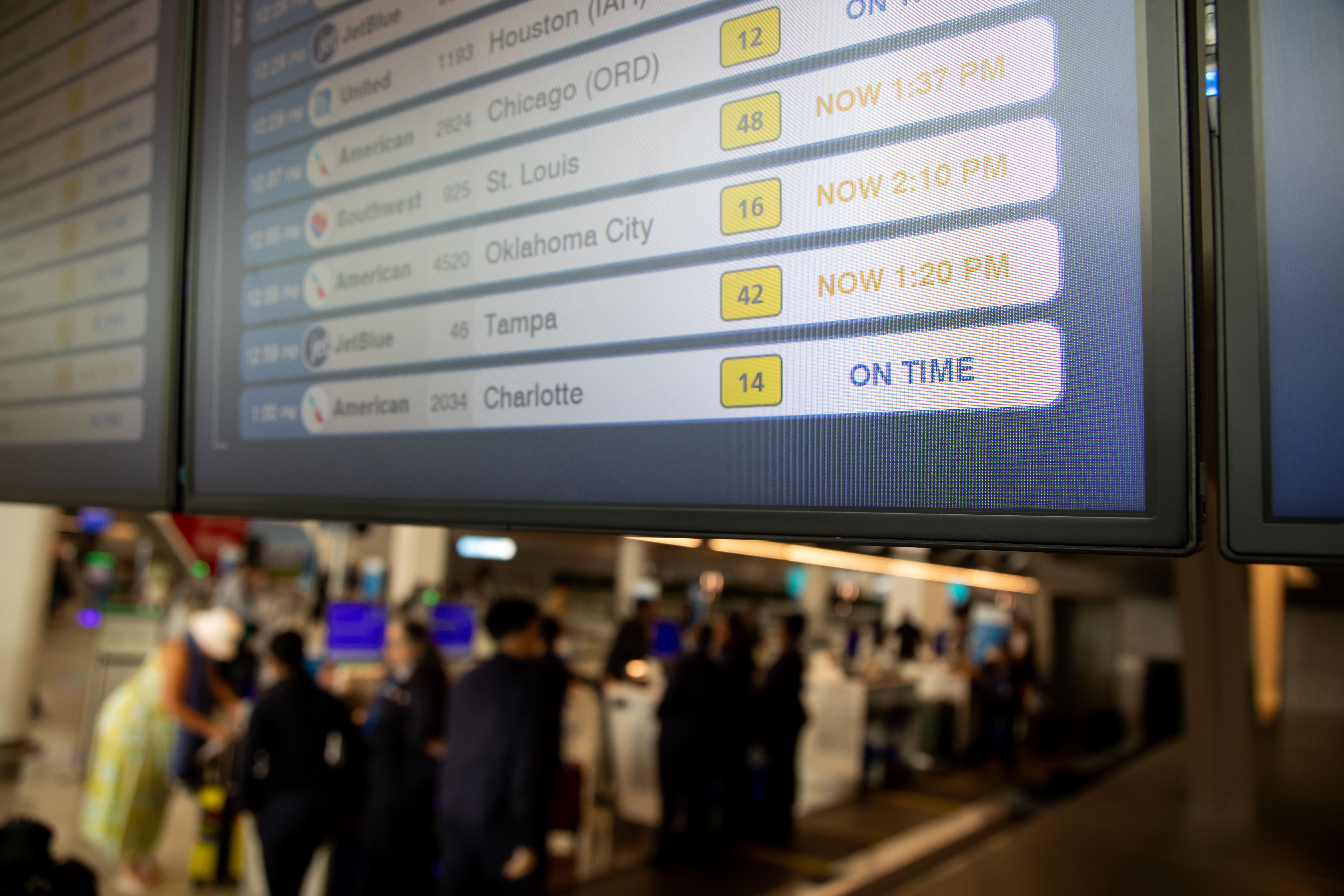 The arrivals board at an airport showing delayed flights.