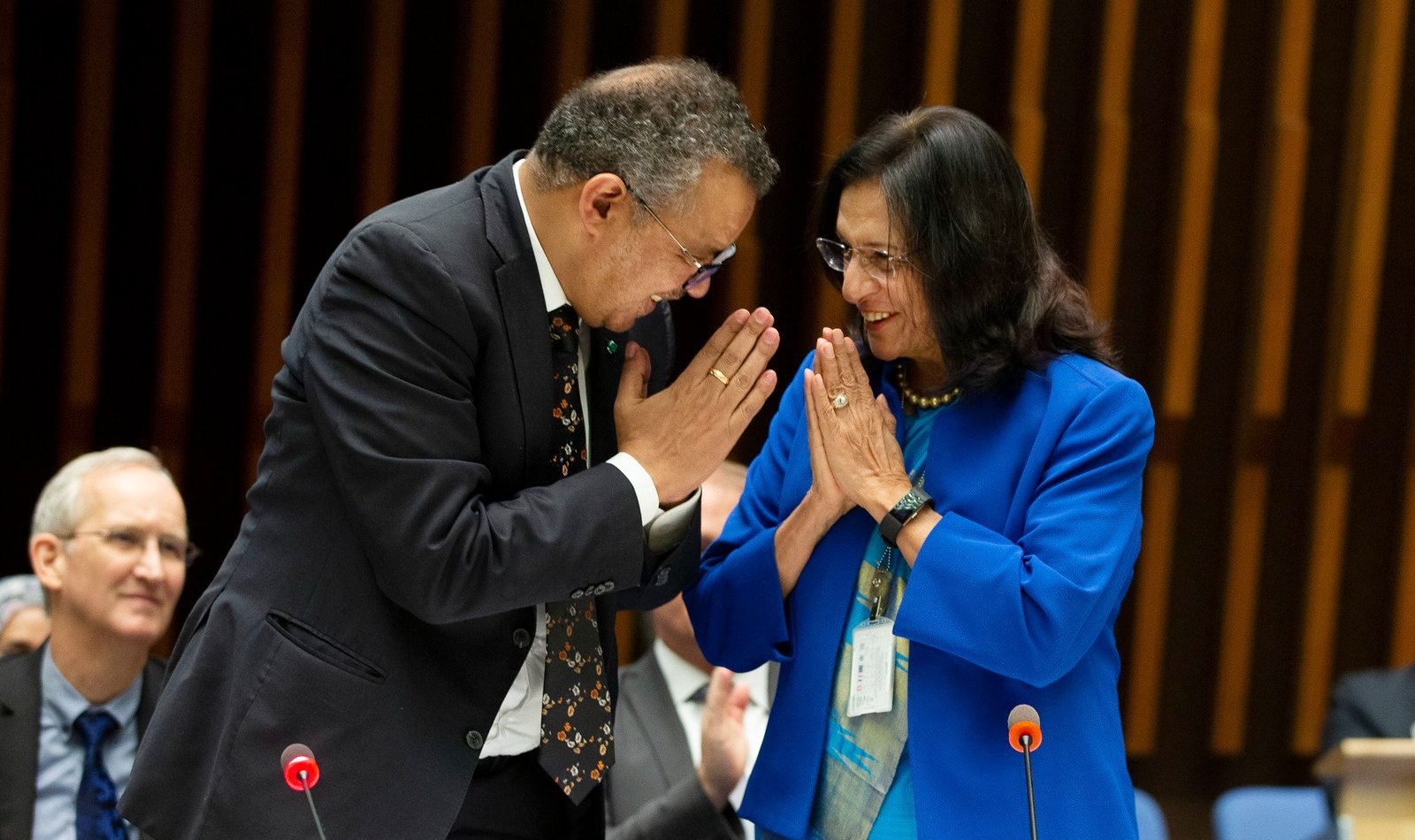 WHO Director-General and Regional Director for SEARO greet each other by joining their palms and bow their heads.