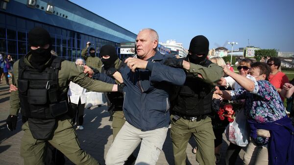 Сотрудники правоохранительных органов задерживают мужчину у во время митинга оппозиции в Минске