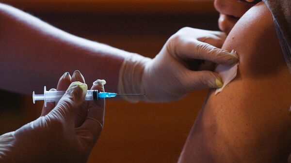 Медицинский сотрудник во время проведения вакцинации от COVID-19