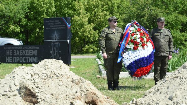 Участники церемонии перезахоронения останков погибших бойцов на мемориальном комплексе Не забудем! Не простим! в Луганске