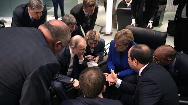  Президент РФ Владимир Путин и федеральный канцлер ФРГ Ангела Меркель во время встречи на полях Международной конференции по Ливии в Берлине
