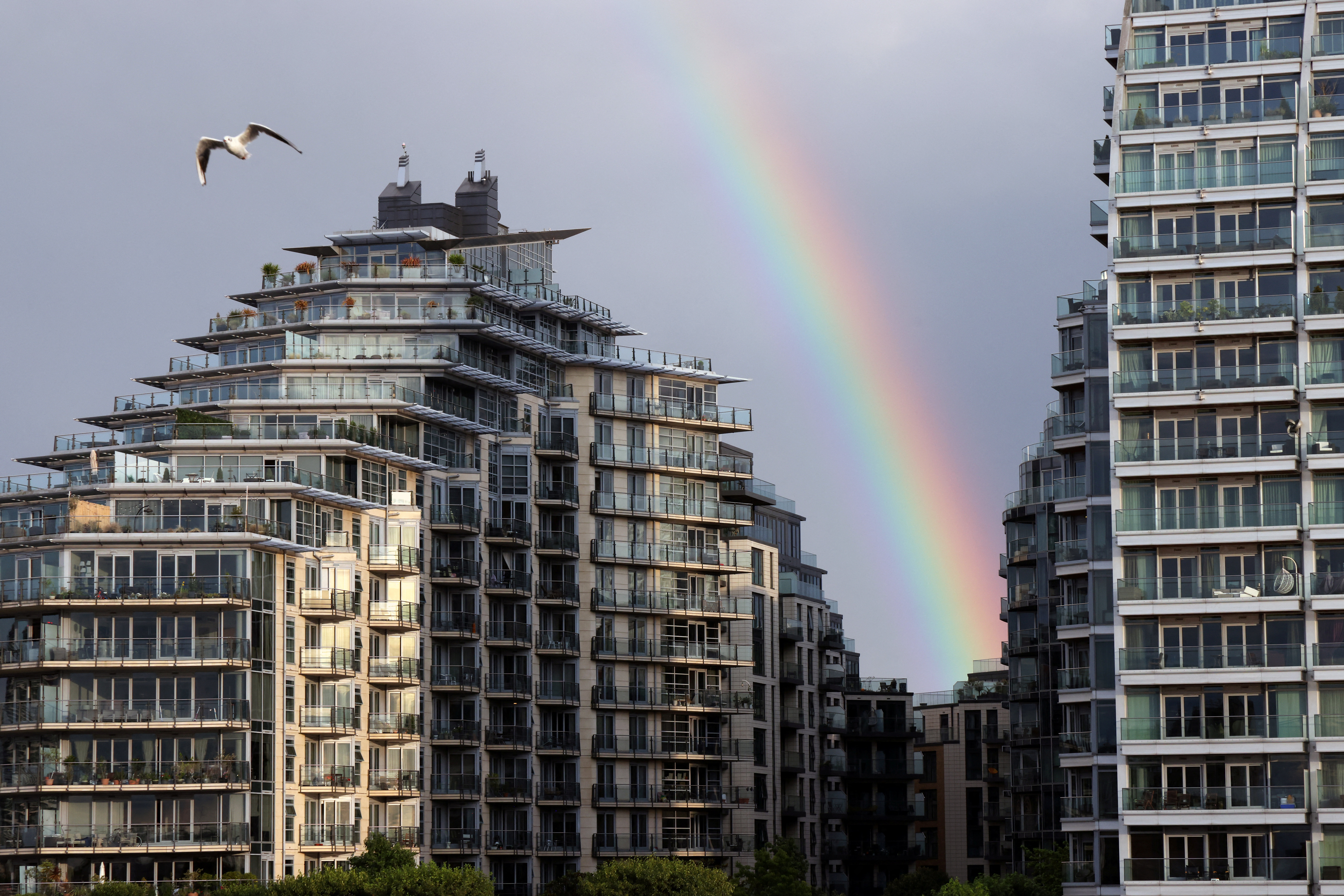 A rainbow is seen over apartments in Wandsworth on the River Thames