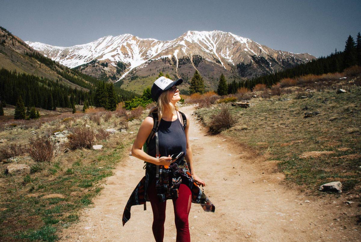 hiker in Colorado with mountains in the background