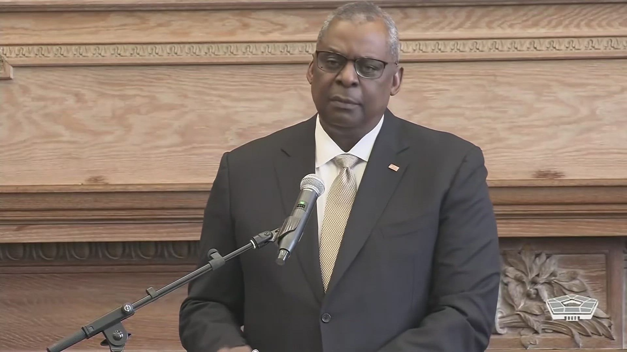 Secretary of Defense Lloyd J. Austin III speaks from a lectern.