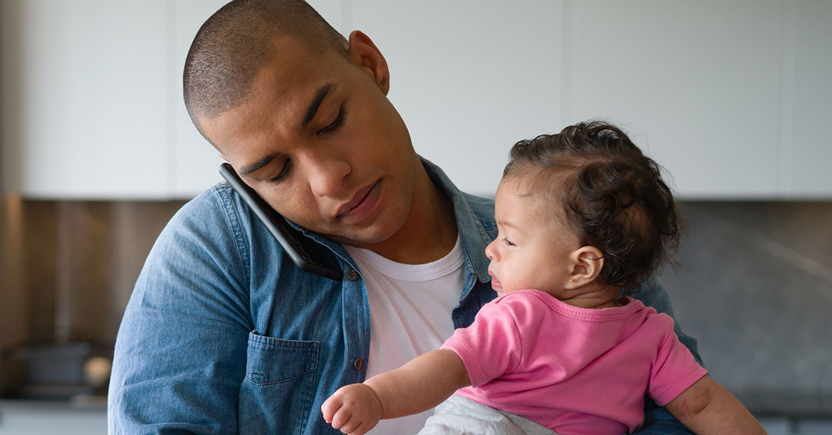 Young adult father holds his infant daughter