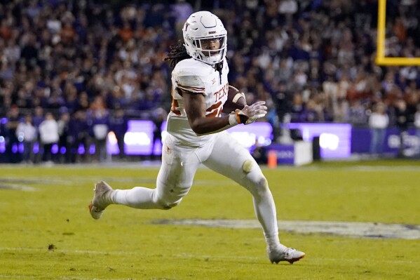 FILE - Texas running back Jonathon Brooks runs free before scoring a touchdown against TCU during the first half of an NCAA college football game, Saturday, Nov. 11, 2023, in Fort Worth, Texas. The Dallas Cowboys are resetting at running back eight years after drafting Ezekiel Elliott. Brooks, who is recovering from a major knee injury, is the highest-rated running back in the draft, according to nfl.com, and the only one among the top 30 prospects. (AP Photo/Julio Cortez, FIle)