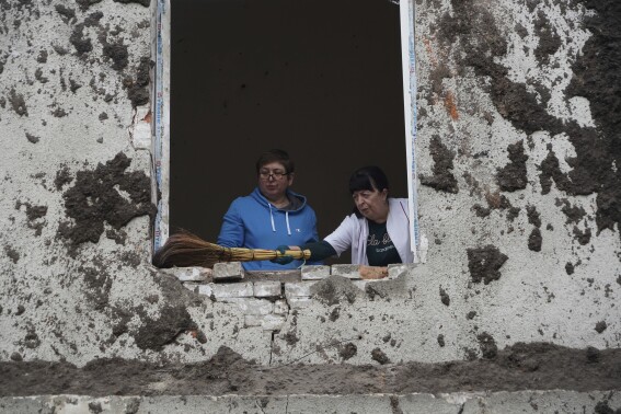 Nurses clean up in the room after a Russian attack on mental hospital №3 in Kharkiv, Ukraine, Saturday, April 27, 2024. (AP Photo/Andrii Marienko)