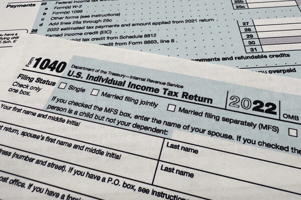 FILE - The Internal Revenue Service 1040 tax form for 2022 is seen on April 17, 2023. The IRS said Friday, April 26, 2024, more than 140,000 taxpayers filed their taxes through its new direct file pilot program. It says the program's users claimed more than $90 million in refunds, saving roughly $5.6 million in fees they would have spent with commercial tax preparation companies. (AP Photo/Jon Elswick, File)