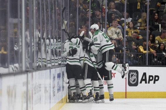 Dallas Stars center Matt Duchene (95) celebrates with teammates after a game winning goal by center Wyatt Johnston (53) during overtime against the Vegas Golden Knights in Game 3 of an NHL hockey Stanley Cup first-round playoff series Saturday, April 27, 2024, in Las Vegas. (AP Photo/Ian Maule)