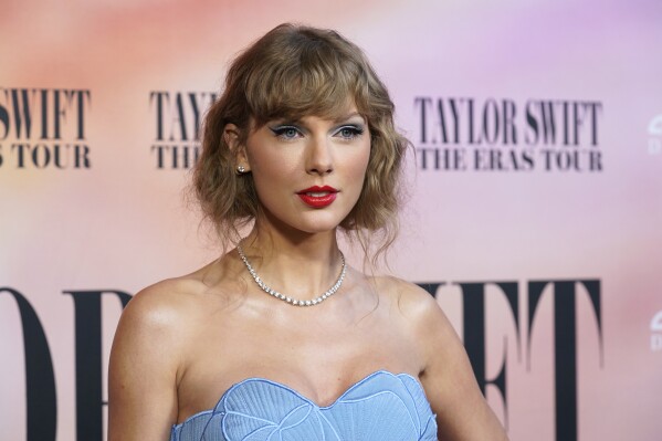 FILE - Taylor Swift arrives at the world premiere of the concert film "Taylor Swift: The Eras Tour" in Los Angeles on Oct. 11, 2023. Swift’s Instagram message encouraging her 283 million followers to register to vote was nominated for a Webby in the best creator or influencer category. (AP Photo/Chris Pizzello, File)