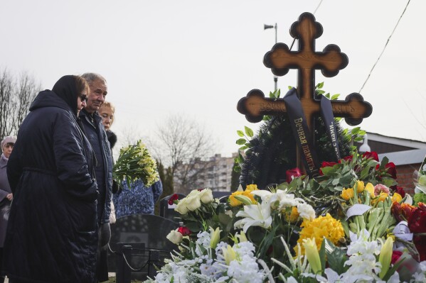 From left, Lyudmila Navalnaya and Anatoly Navalny, parents of Russian opposition leader Alexei Navalny, and Navalny's mother-in-law Alla Abrosimova visit the grave of the late Russian opposition leader son on the fortieth day after his death as per Orthodox tradition at the Borisovskoye Cemetery, in Moscow, Russia, Tuesday, March 26, 2024. (AP Photo/Vitaly Smolnikov)