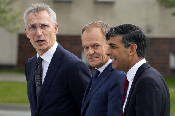 Britain's Prime Minister Rishi Sunak, right, Poland's Prime Minister Donald Tusk, center, and NATO Secretary General Jens Stoltenberg, right, visit the Armourd Brigade barracks in Warsaw, Poland, Tuesday, April 23, 2024. (AP Photo/Czarek Sokolowski)