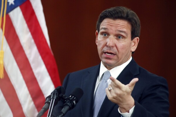 FILE - Florida Gov. Ron DeSantis answers questions from the media, March 7, 2023, at the state Capitol in Tallahassee, Fla. Florida school districts can opt to allow volunteer chaplains under a bill signed Thursday, April 18, 2024, by DeSantis, who dismissed critics who say religion shouldn't be mixed with public education. (AP Photo/Phil Sears, File)