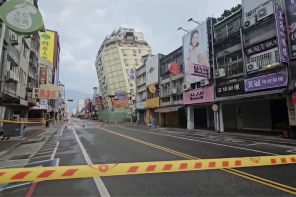 In this image from a video, roads in Hualien, Taiwan are cordoned off after a cluster of earthquakes struck the island early Tuesday, April 23, 2024. There were no reports of casualties in the quakes, although there were further damages to two multi-story buildings that had been evacuated following a magnitude 7.4 quake that hit the island earlier this month, killing 13 people and injuring over 1,000. (TVBS via AP)