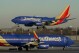 FILE - Southwest Airlines plane prepares to land at Midway International Airport, Feb. 12, 2023, in Chicago. Flight attendants at Southwest Airlines on Wednesday, April 24, 2024, ratified a contract that includes pay raises totaling more than 33% over four years, as airline workers continue to benefit from the industry's recovery since the pandemic. (AP Photo/Kiichiro Sato, File)