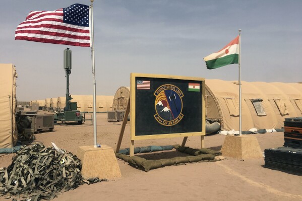 FILE - A U.S. and Niger flag are raised side by side at the base camp for air forces and other personnel supporting the construction of Niger Air Base 201 in Agadez, Niger, April 16, 2018. The United States is attempting to create a new military agreement with Niger that would allow it to remain in the country, weeks after the junta said its presence was no longer justified, two Western officials told The Associated Press Friday April 19, 2024. (AP Photo/Carley Petesch, File)