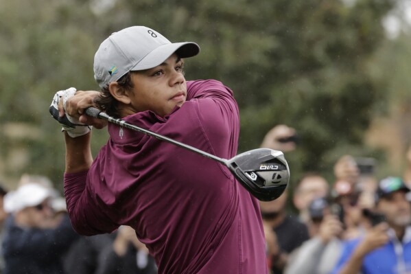 FILE - Charlie Woods tees off during the final round of the PNC Championship golf tournament Sunday, Dec. 17, 2023, in Orlando, Fla. Charlie Woods, the 15-year-old son of Tiger Woods, failed to qualify for his first U.S. Open after shooting 9-over 81 on Thursday, April 25, 2024, at Legacy Golf & Tennis Club in Port St. Lucie, Florida.(AP Photo/Kevin Kolczynski, File)